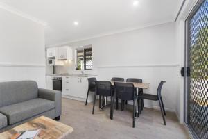 a living room with a couch and a table and chairs at Ingenia Holidays Townsville in Townsville