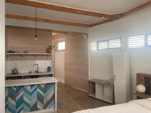 a kitchen with a counter and a sink in a room at Hostal CKAIR in Bahia Inglesa