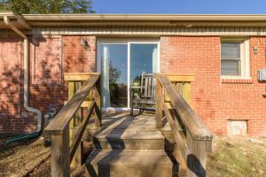 a wooden deck in front of a brick building at Cozy 3 bed 2 bath Cottage Near Nichols Hills in Oklahoma City