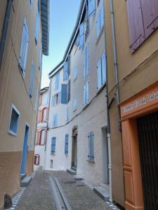 an alley between two buildings in a city at ∞ Hyper centre ∞ La marmotte ∞ petit T2 ∞ entrée24h/24 ∞ près ski/cure ≈AX-LES-THERMES≈ wifi ∞ in Ax-les-Thermes