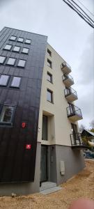 a tall building with a black and white at Nivalis Hill N&V in Jahorina