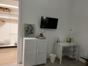 a room with a tv on a wall with a table at Fiore di Marte in Marsala