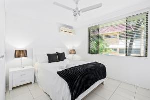 a white bedroom with a bed and a window at Coco Bella Dream in Surfers Paradise in Gold Coast +14 photos