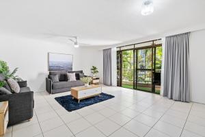 a living room with a couch and a table at Coco Bella Dream in Surfers Paradise in Gold Coast