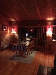 uma sala de jantar com uma mesa e cadeiras num quarto em Macktunet - Retro log cabin from the 70s in Malangen 