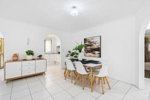 a kitchen and dining room with a table and chairs at Coco Bella Dream in Surfers Paradise in Gold Coast