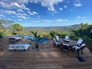a deck with a table and chairs and a pool at Balmoral 575 in Montville