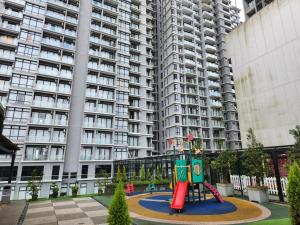 a playground in front of a large apartment building at Genting Ion Delemen TopSky Holiday Suite & Studio Room in Genting Highlands