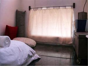 A bed or beds in a room at Kenting Sun Light Inn