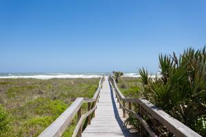a wooden boardwalk leading to the beach at Seaside Bungalow in Saint Augustine
