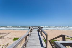 a wooden boardwalk leading to the beach at Seaside Bungalow in Saint Augustine