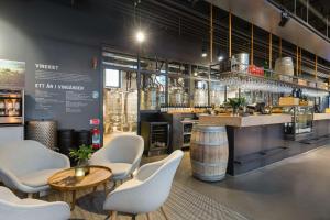a restaurant with a bar with chairs and a table at The Winery Hotel, WorldHotels Crafted in Solna