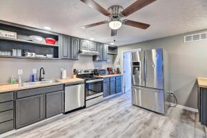 a kitchen with stainless steel appliances and blue cabinets at Cozy Newport Cottage Near Stadiums and Downtown in Newport