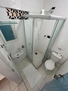 a bathroom with a shower and a toilet and a sink at Casa da Lua Buzios in Búzios