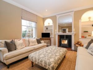 a living room with a couch and a fireplace at The Middle House in Southwold