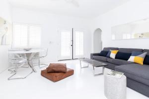 a living room with a couch and a table at Alcazar Palm Springs in Palm Springs