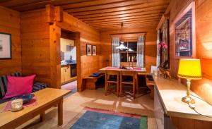 a log cabin kitchen with a desk and a table at Chalets Ebner in Eben im Pongau