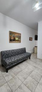 a black couch in a room with a painting on the wall at Esmeralda Apartment in Buenos Aires