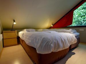 ein Schlafzimmer mit einem großen Bett in einem Zelt in der Unterkunft Uilenpad 16 in Haaren
