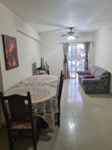 a living room with a table and a couch at Departamento centro Santiago del Estero in Santiago del Estero
