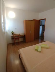 a bedroom with a bed and a table and a desk at Apartment Kornic 5306b in Kornić