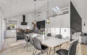 a dining room and kitchen with a table and chairs at 4 Bedroom Nice Home In Glesborg in Glesborg