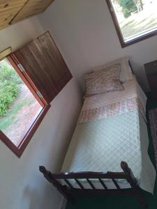 En eller flere senge i et værelse på Chalé Limoeiro á 15 minutos de Gonçalves MG