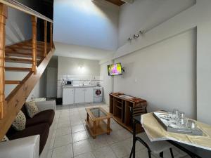 a living room with a couch and a table and a kitchen at Cielo Sureño in Río Gallegos