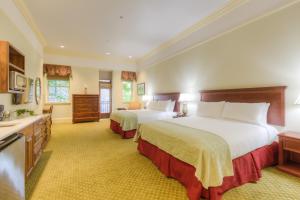 a large bedroom with two beds and a sink at Diamond Hotel in Chico