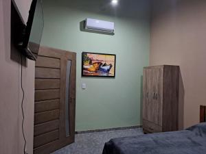 a bedroom with a bed and a dresser and a window at Pousada Rio e Mar in Fortim