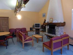 a living room with a fireplace and tables and chairs at Gîte Cirfontaines-en-Ornois, 6 pièces, 12 personnes - FR-1-611-30 