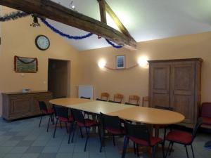 a room with a table and chairs and a clock at Gîte Cirfontaines-en-Ornois, 6 pièces, 12 personnes - FR-1-611-30 