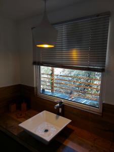 a bathroom with a sink and a large window at Altos del Monte in Villa Rumipal +14 photos