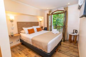 Postel nebo postele na pokoji v ubytování Tagle Hotel Boutique