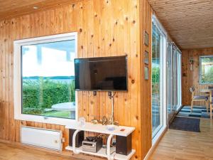 a living room with a large window and a tv at 4 person holiday home in Aabenraa-By Traum in Aabenraa