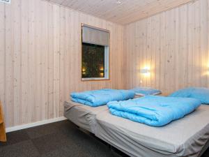 a room with two blue pillows on top of a bed at 4 person holiday home in Aabenraa-By Traum in Aabenraa