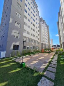 a large white building with a street in front of it at Apartamento Autódromo de Interlagos sp in Sao Paulo