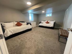 a bedroom with two beds and a chair in it at Quaint new renovation perfect for your large group in Billings