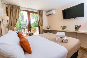 Postel nebo postele na pokoji v ubytování Tagle Hotel Boutique