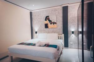 1 dormitorio con 1 cama y una pintura en la pared en Alona Northland Resort, en Panglao