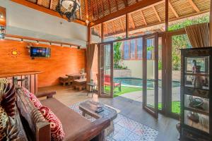 a living room with a couch and a table at Villa Kanha by Bukit Vista in Jimbaran