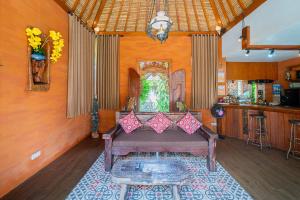 a living room with a couch in a room at Villa Kanha by Bukit Vista in Jimbaran