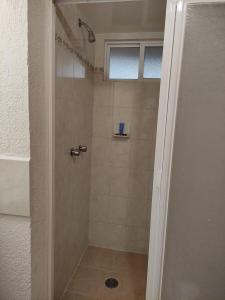 a shower with a glass door in a bathroom at Hotel La Rinconada Tequisquiapan in Tequisquiapan