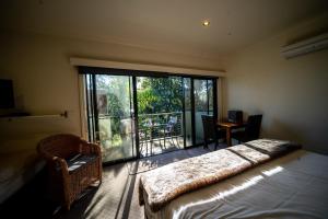 a bedroom with a bed and a large window at Deville At Healesville in Healesville
