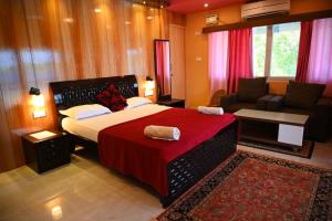 - une chambre avec un grand lit et une couverture rouge dans l'établissement The Seaview Residency, à Port Blair