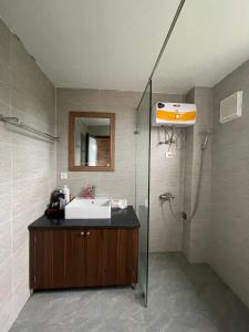 a bathroom with a sink and a shower at Đường Lâm homestay - House Number 9 in Sơn Tây