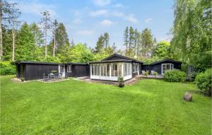 a large yard with a black and white house at Nice Home In Ebeltoft With Wifi in Ebeltoft