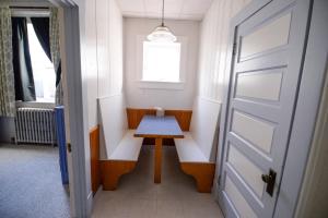 a small wooden table in a room with a door at Brown & Hawkins Historical Apartments in Seward