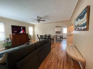 a living room with a couch and a dining room at Snug, neighborly home perfect for your small group in Billings