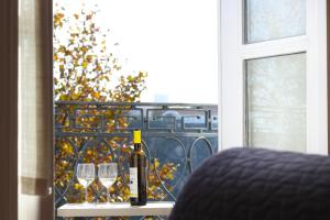 a bottle of wine sitting on a table with two glasses at Fontainhas River Residence in Porto